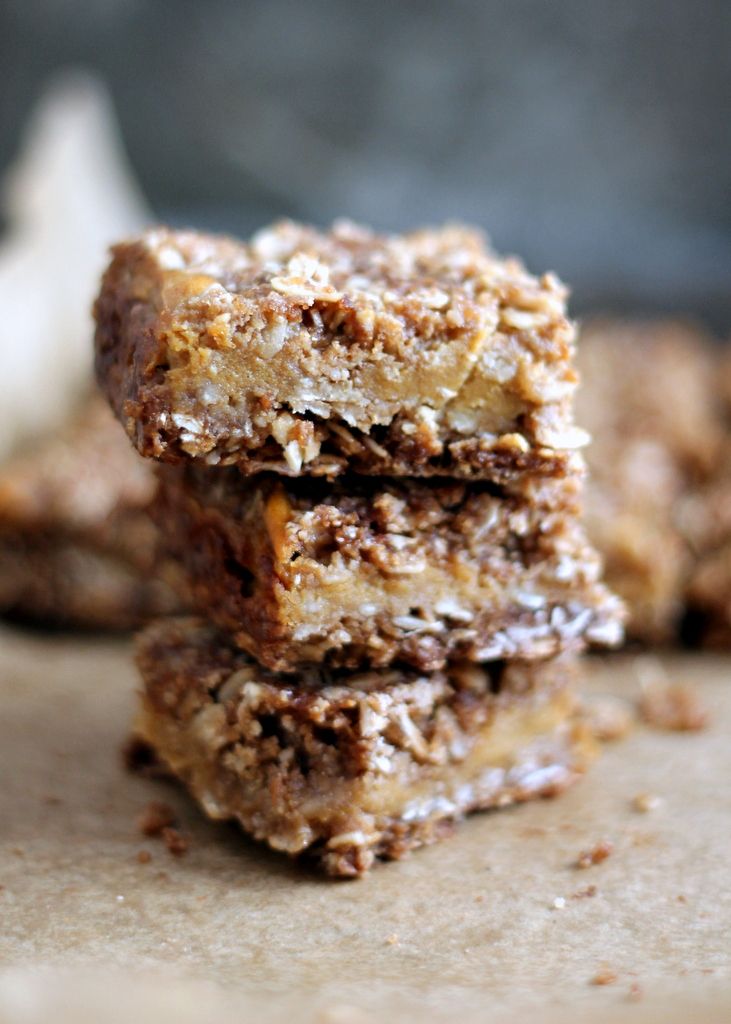 three pieces of granola bar stacked on top of each other with one bite taken out