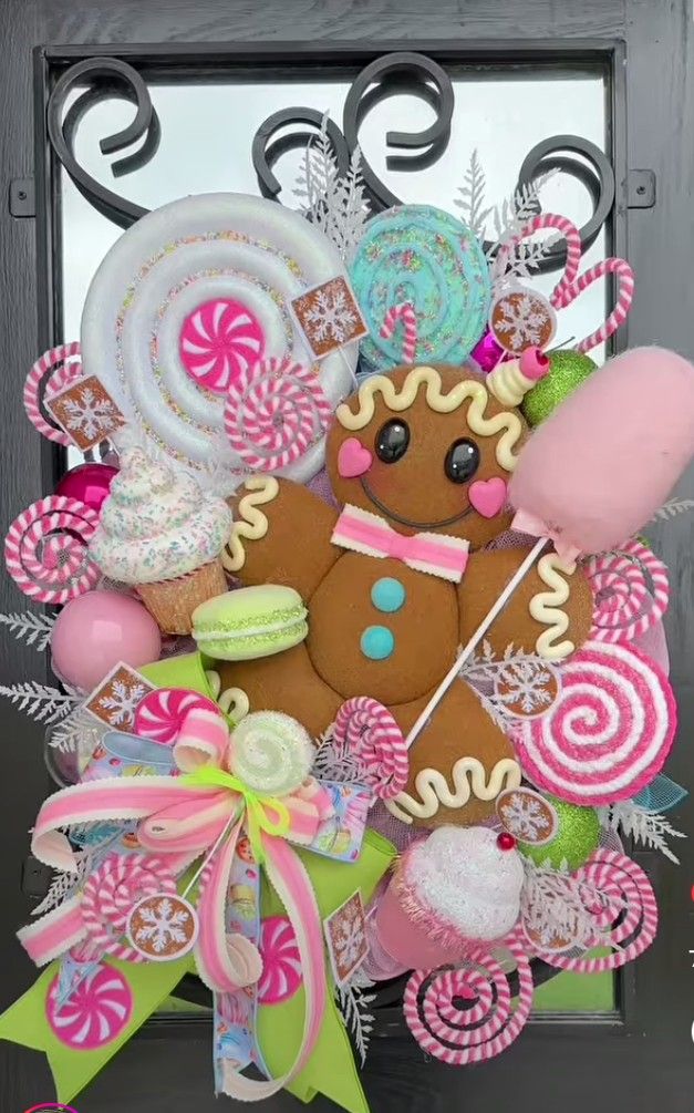 a wreath made out of candy, lollipops, and a gingerbread man