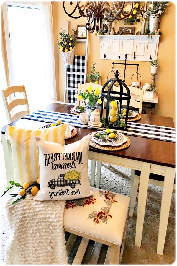 the dining room table is set with yellow and white decor