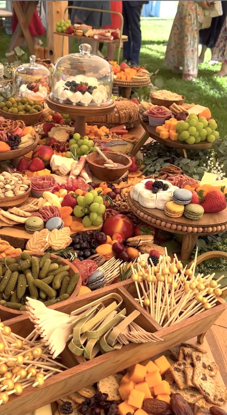 a table filled with lots of different types of food on it's trays