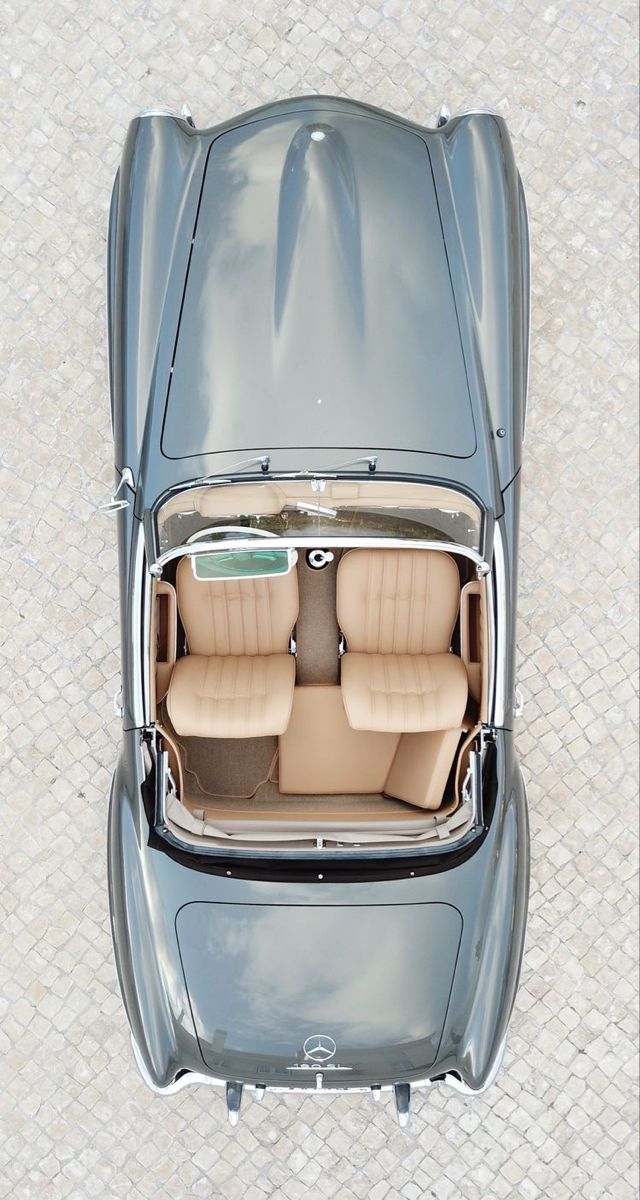 an overhead view of a car with its doors open and seats folded down on the floor