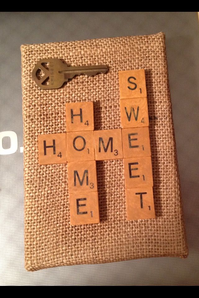 scrabble tiles with words on them and a key hanging from the middle one