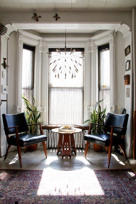 a living room with two chairs and a table