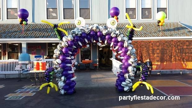 an arch made out of balloons in front of a building