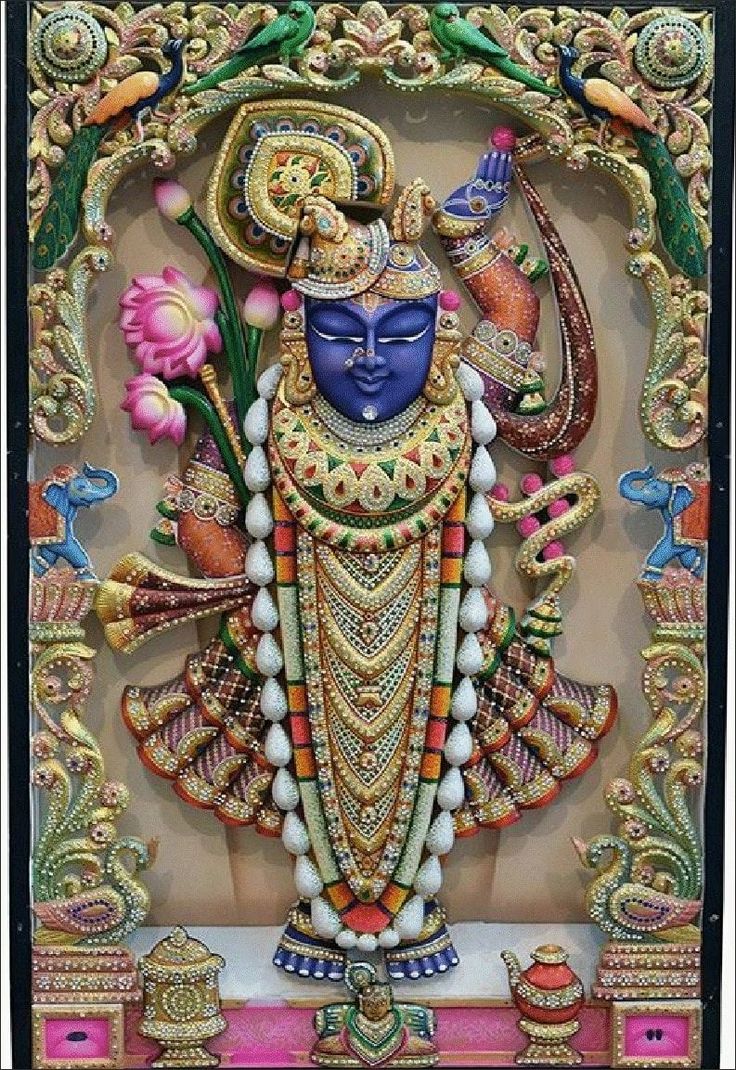 an intricately decorated wall hanging depicting the hindu god