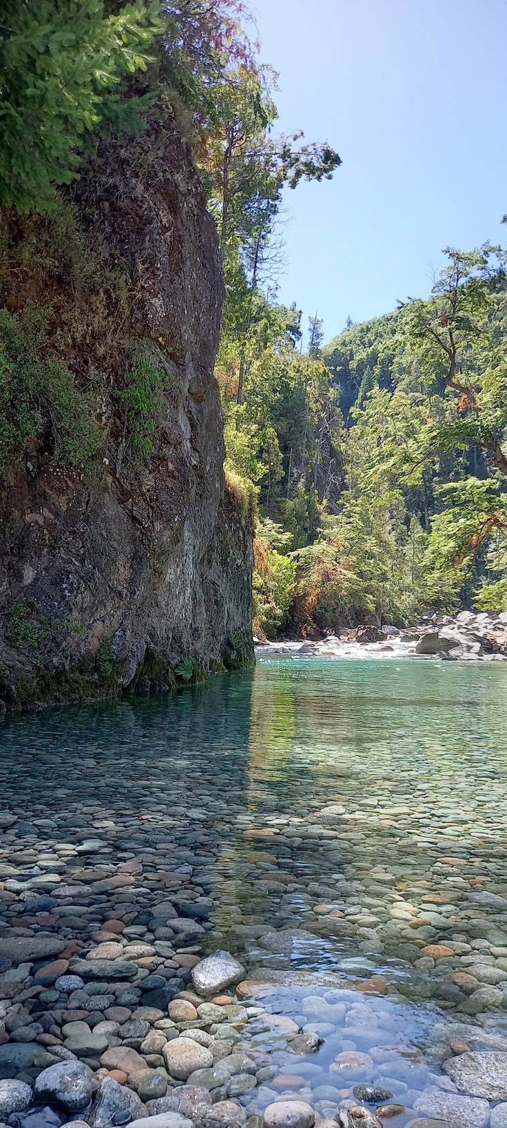 the water is crystal blue and there are rocks in it