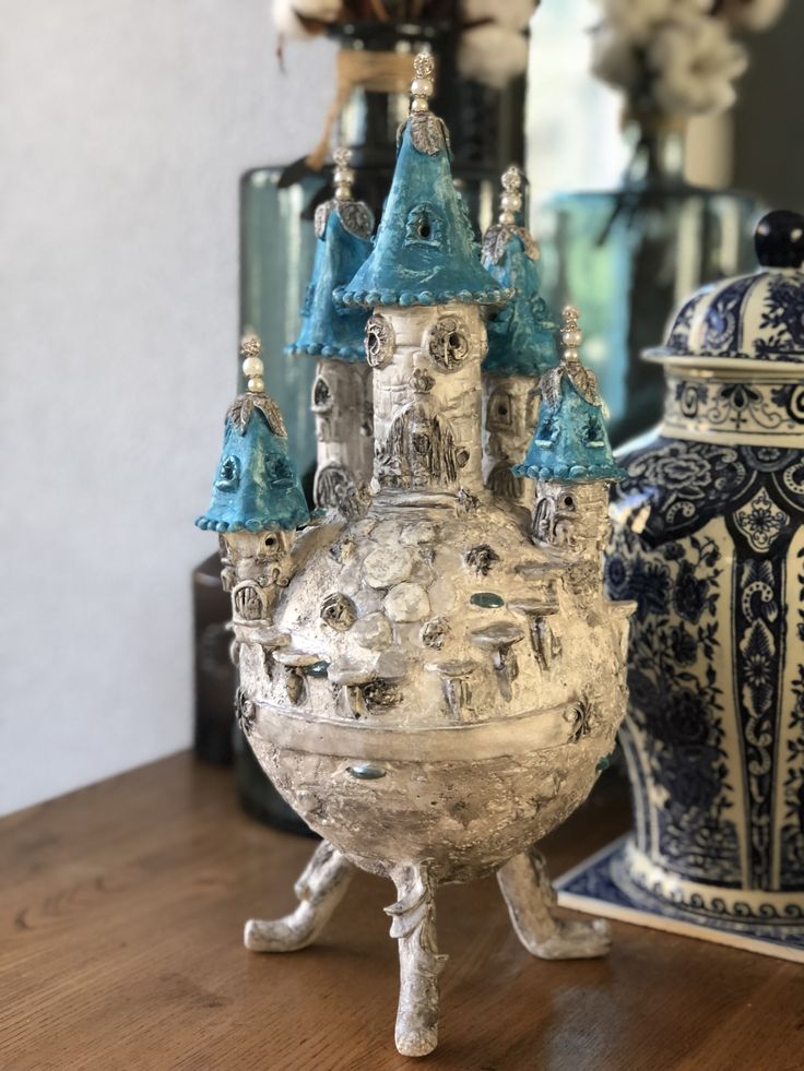 a blue and white vase sitting on top of a wooden table