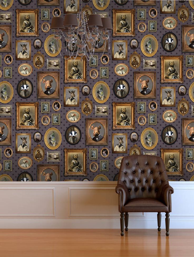 a brown chair sitting in front of a wall with pictures on it and a chandelier hanging from the ceiling