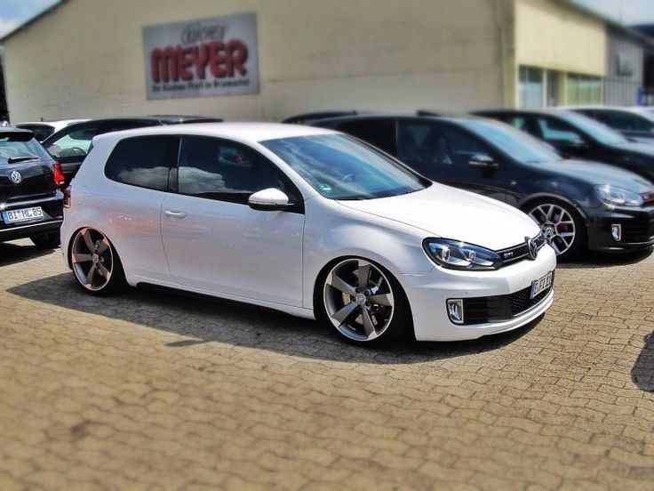 a white car parked in front of a building