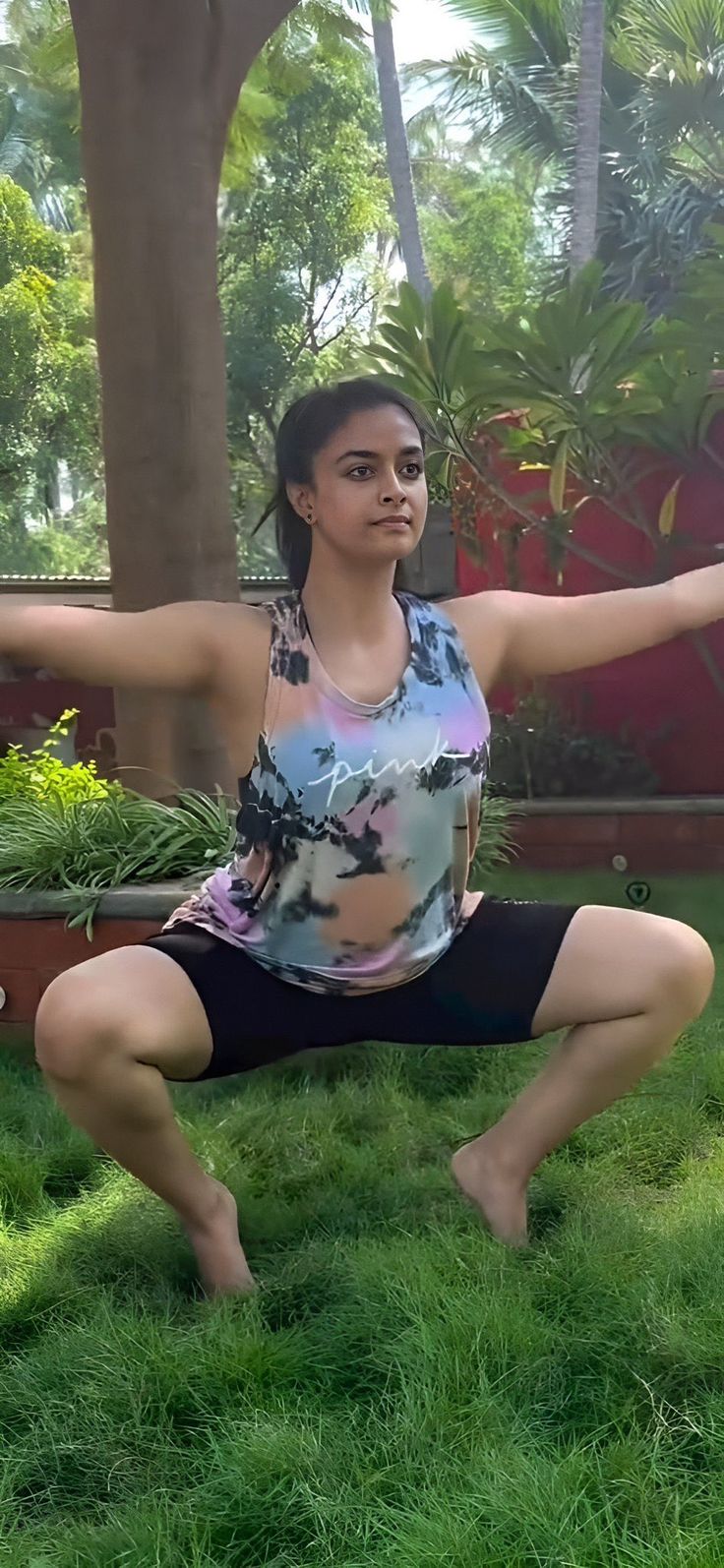 a woman is doing yoga outside in the grass