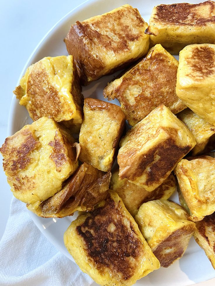 there are many pieces of bread on the plate and one is cut into cubes