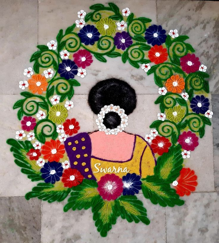 a woman's face is surrounded by flowers and leaves on the floor in front of a stone wall