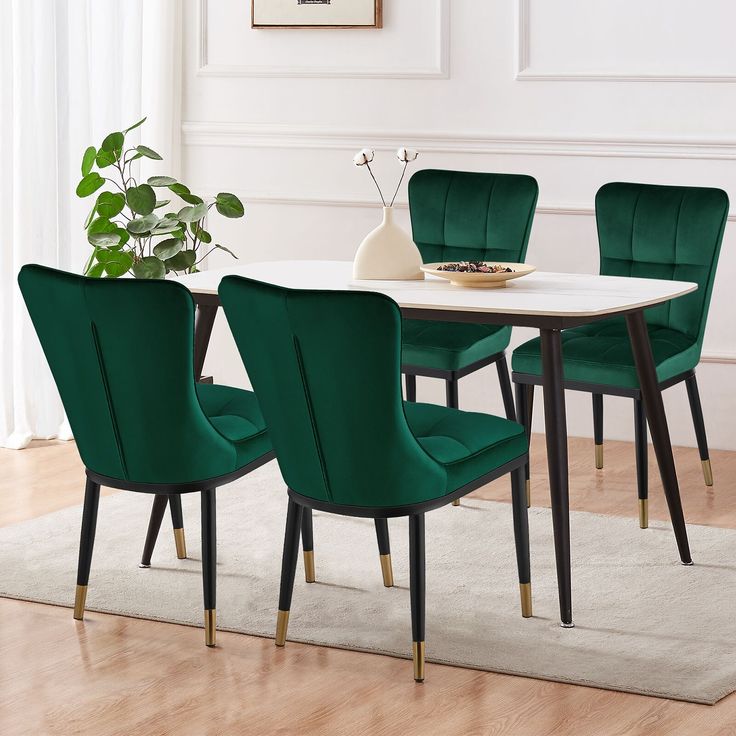 a dining room table with green chairs and a white rug on the floor in front of it