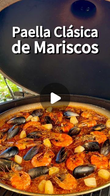 a large pan filled with food sitting on top of a grill