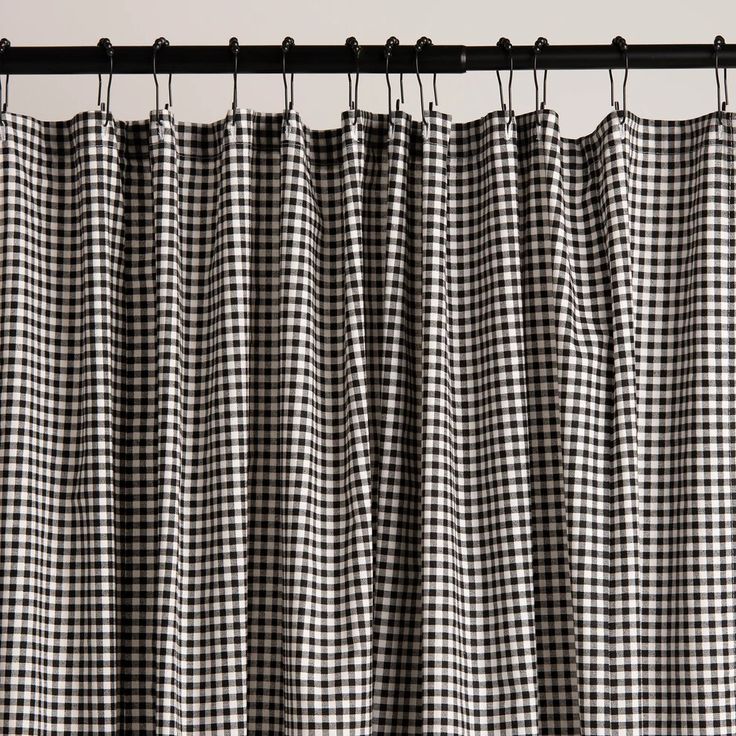 a black and white checkered curtain hanging from a metal rod