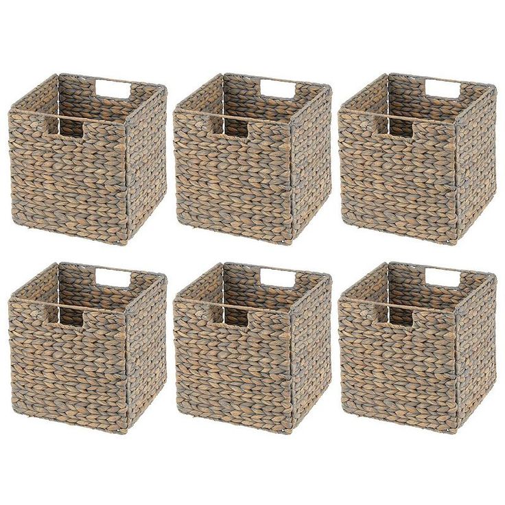 four baskets with clothes in them sitting next to each other