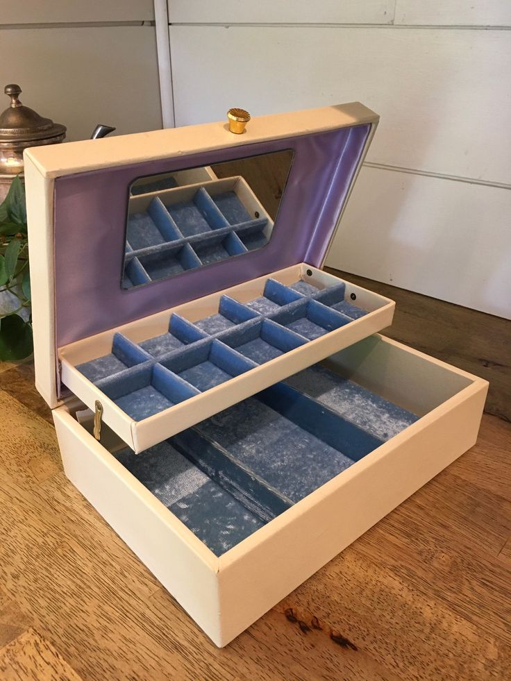 an open jewelry box on a wooden table