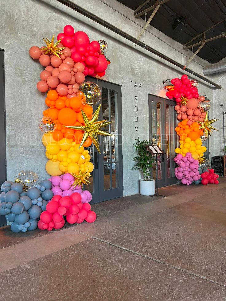 balloons are arranged in the shape of a rainbow