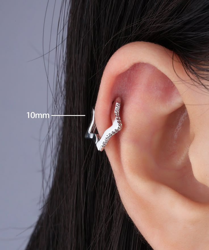 an ear piercing is shown with the measurements