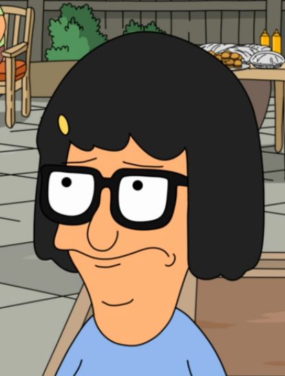 an animated image of a woman with glasses and black hair, sitting in front of a table