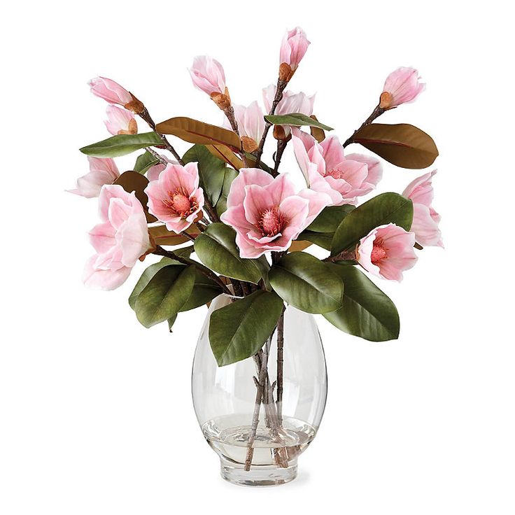 a vase filled with pink flowers and green leaves