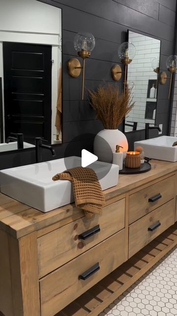 a bathroom with two sinks and mirrors on the wall next to each other in front of a large mirror