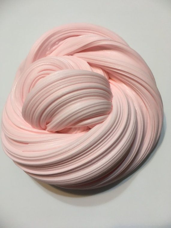 a ball of pink yarn sitting on top of a white table