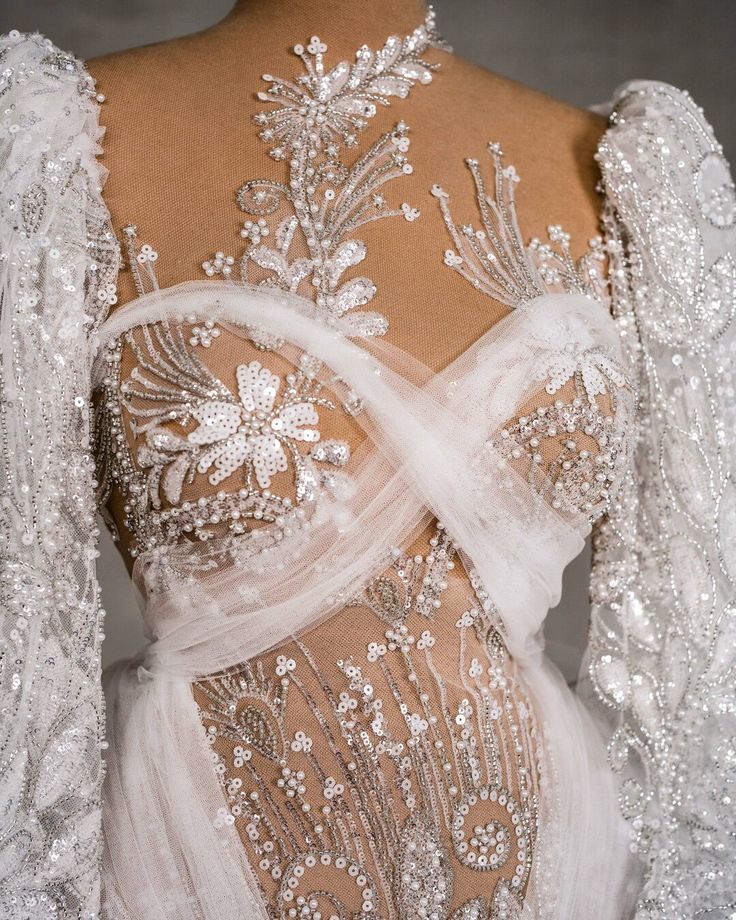 the back of a wedding dress with beading on it