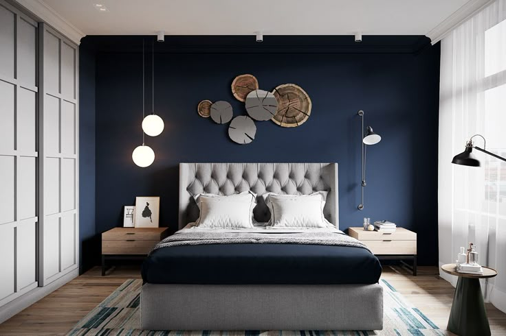 a bedroom with blue walls and white bedding is pictured in this image, there are round lights on the wall above the bed