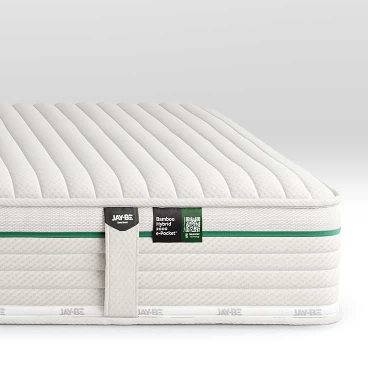 the mattress is white and has green stripes on it's side, with a black tag