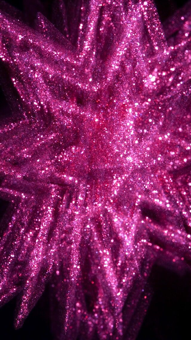 pink glitter sparkles against a black background