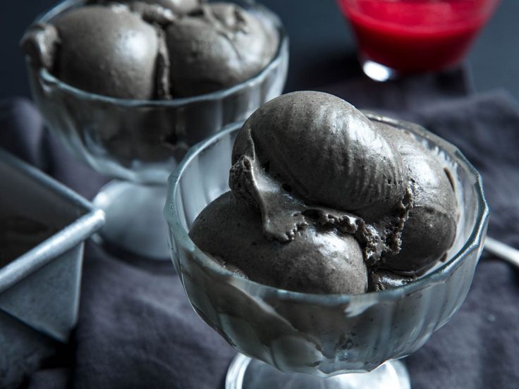 two glass bowls filled with ice cream on top of a table