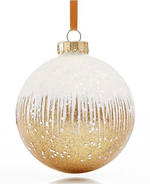 a gold and white ornament with icing on it's side against a white background