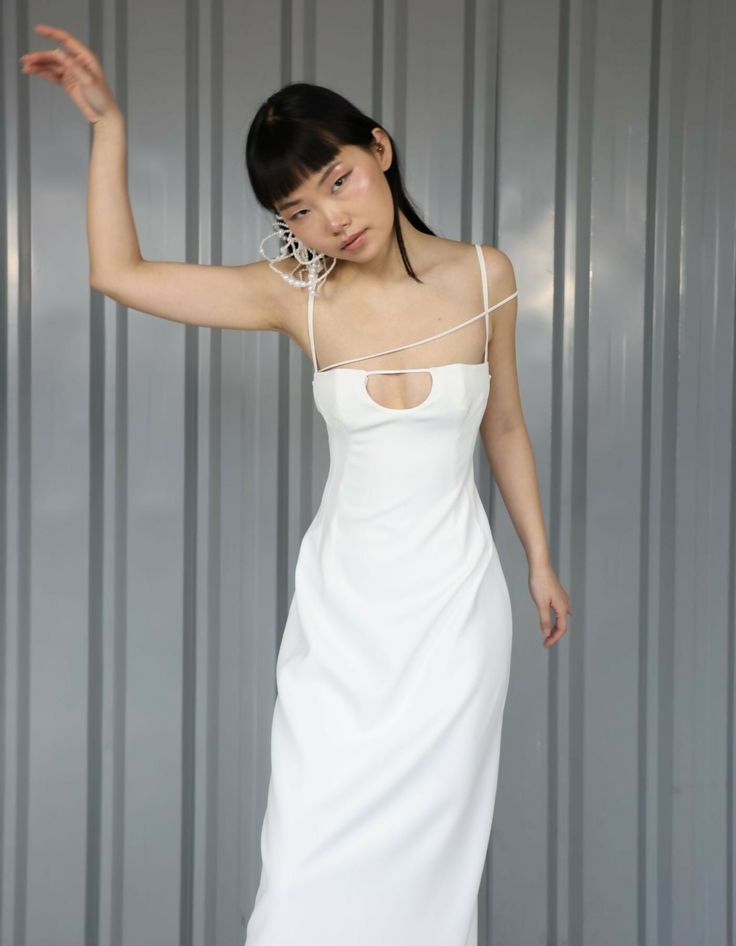 Step into contemporary elegance with the ethereal allure of the STATUTE White Crepe Maxi Dress from the Maet wedding collection LUMEN. Crafted from premium white crepe fabric, this gown boasts a sleek silhouette that exudes modern glamour. The bodice features intricate detailing with 3D strings adding a hint of allure, while a meticulously tailored corset underneath ensures a flawless fit that accentuates every curve. Ideal for the modern bride seeking a blend of timeless charm and contemporary flair, this dress is a true statement piece that will enchant all who behold it.*At MAET, we make sure every inch feel just right as you walk down the aisle or for your special event. In order to feel stunning on your big day, we offer custom fit. Provide us your measurements and we’ll assure your f Statue Wedding, Once Upon A Time Wedding, Straight Wedding Dresses, Wedding Dress Backs, Crepe Maxi Dress, Wedding Dressses, Walk Down The Aisle, Modern Wedding Dress, The Modern Bride