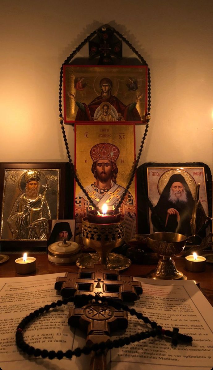 an altar with candles and pictures on it