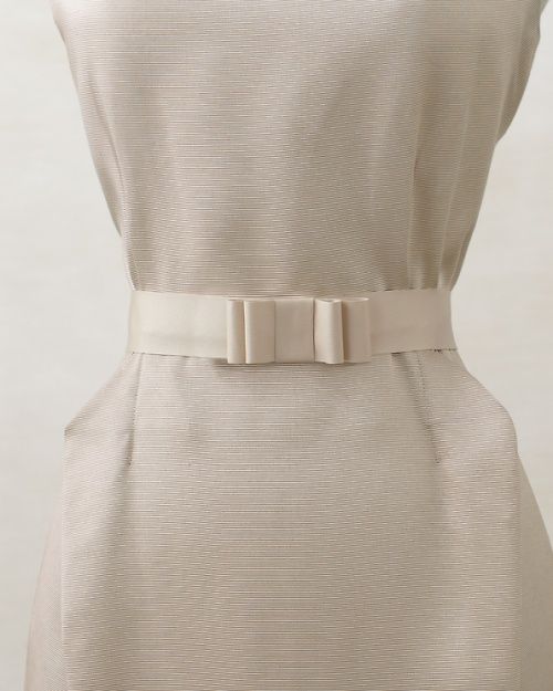 a white dress on a mannequin dummy with a belt around it's waist