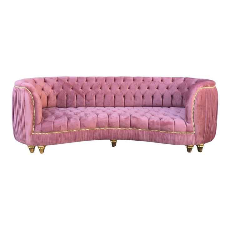 a pink velvet couch with gold trimmings on the legs and back, against a white background