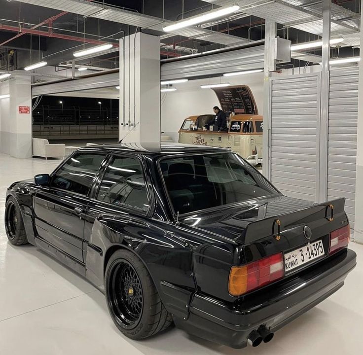 a black car is parked in a garage