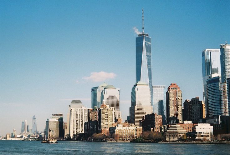 the skyline of new york city with one world trade center in the foreground