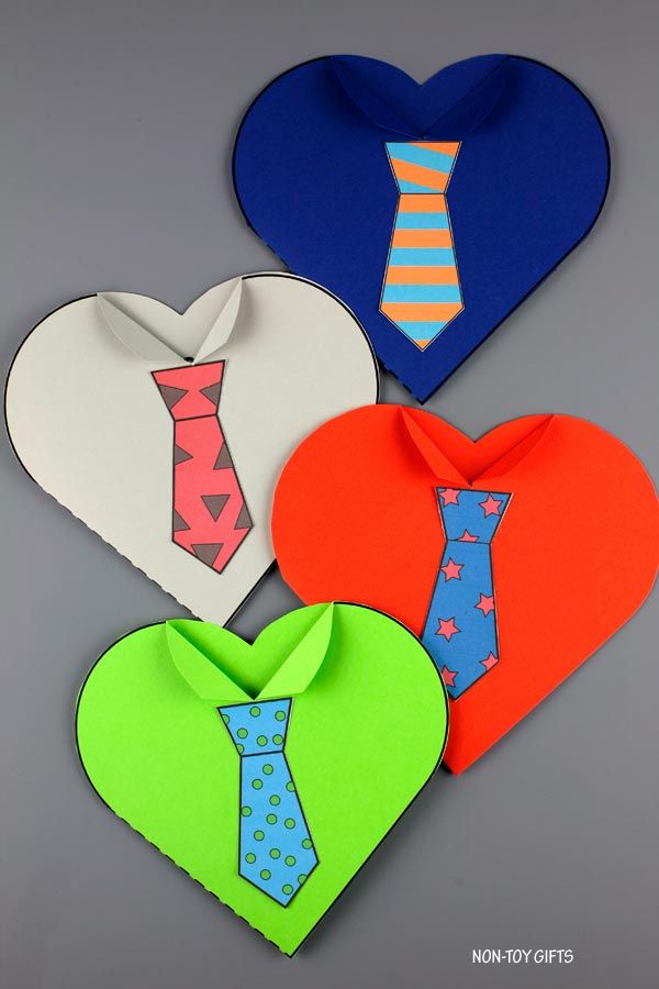 four heart shaped paper pieces with ties on them