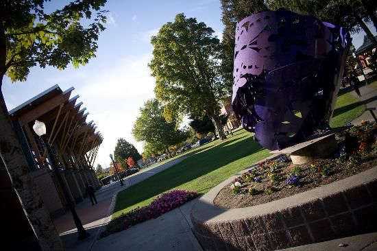 a purple sculpture sitting in the middle of a park