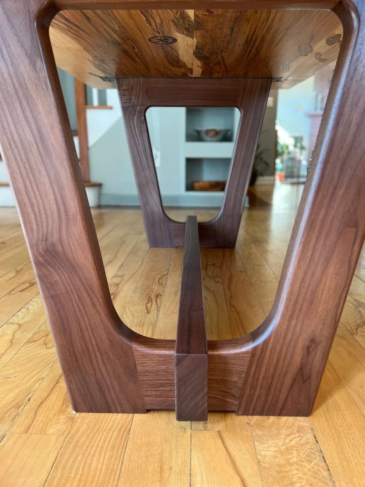 a wooden table sitting on top of a hard wood floor