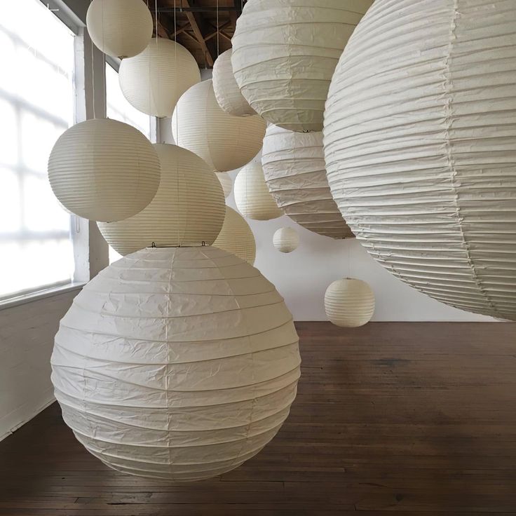 several white paper lanterns hanging from the ceiling