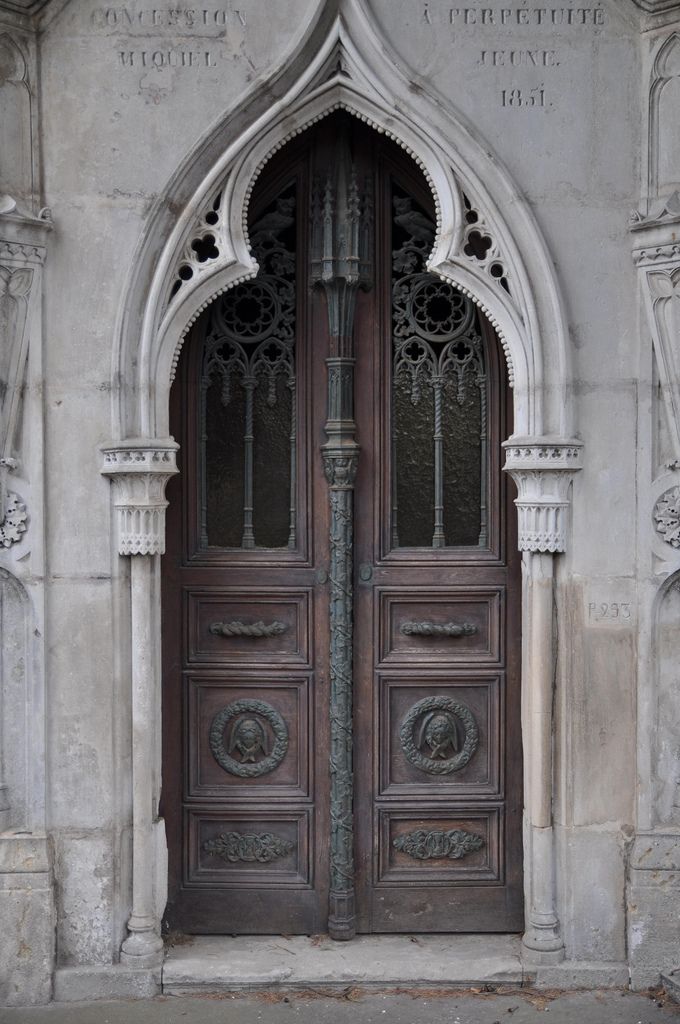 an old church door with ornate carvings on the front and side doors that lead into another building