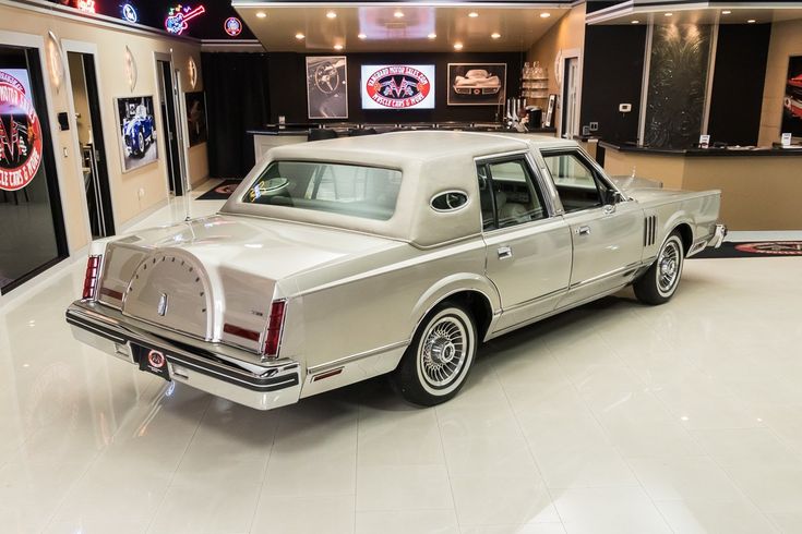 an old car is parked in a showroom