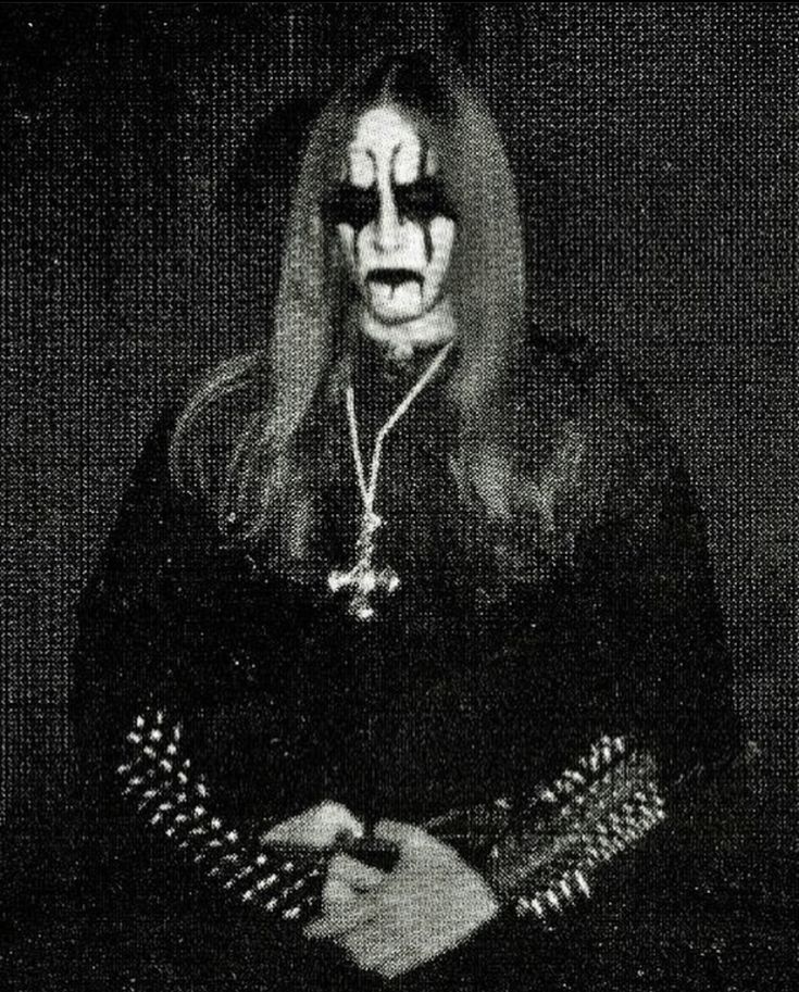 an old photo of a man with makeup on his face and hands in front of him