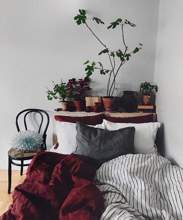 a bed with two plants on top of it