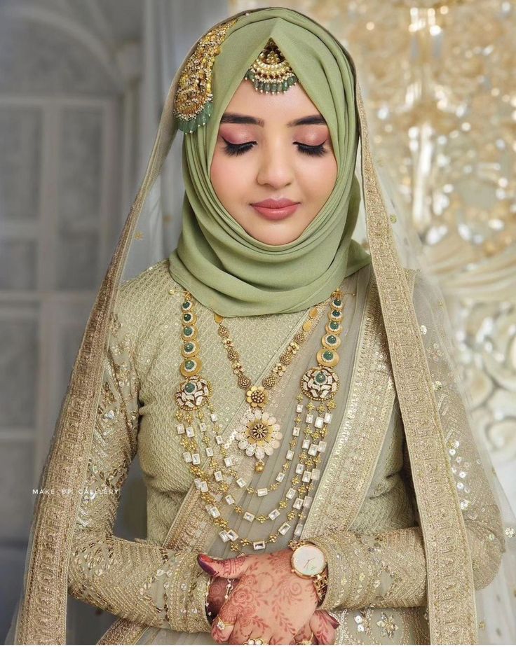 a woman wearing a hijab and jewelry