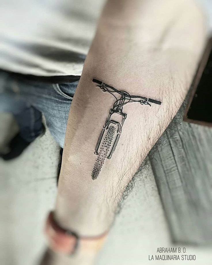 a man with a bike tattoo on his arm