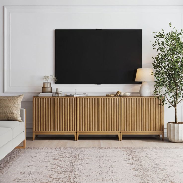 a living room with a large flat screen tv on the wall